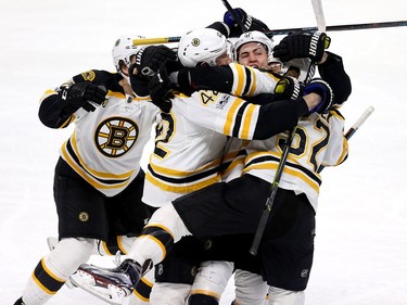 The Boston Bruins celebrate their double-overtime win.