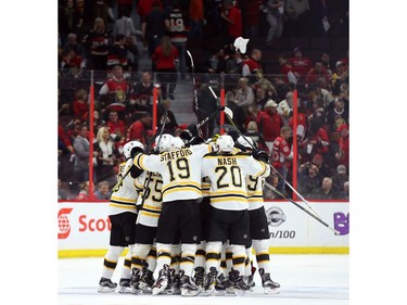 The Boston Bruins celebrate their double-overtime win.