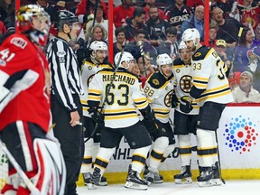 Bruins captain Zdeno Chara, far right, joins teammates in celebrating the team's first goal.