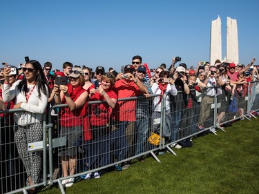 VIMY, FRANCE - APRIL 09: Members of the crowd take pictures from behind a barrier as VIPs arrive at the Canadian National Vimy Memorial on April 9, 2017 in Vimy, France. The Prince of Wales, The Duke of Cambridge and Prince Harry along with Canadian Prime Minister Justin Trudeau and French President Francois Hollande attend the centenary commemorative service at the Canadian National Vimy Memorial. The Battle Of Vimy Ridge was fought during WW1 as part of the initial phase of the Battle of Arras. Although British-led it was mostly fought by the Canadian Corps.
