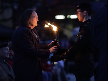 The Flame of Remembrance is passed during a ceremony.