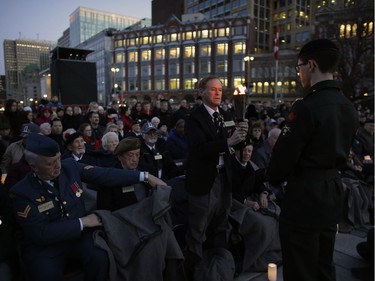 The Flame of Remembrance is passed during a candlelight ceremony at the National War Memorial on Saturday, April 8, 2017, to mark the 100th anniversary of the Battle of Vimy Ridge.