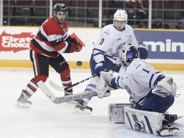 The Mississauga Steelheads goaltender Jacob Ingham makes a save as Ottawa 67s Patrick White, left, and the Steelheads Michael McLeod look on during third period action of their OHL playoff hockey game at TD Place in Ottawa on Sunday, April 2, 2017.   (Patrick Doyle)  ORG XMIT: 0402 67s 06