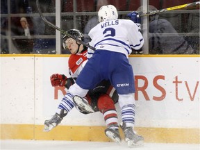 The Mississauga Steelheads Ryan Wells hits the Ottawa 67s Artur Tyanulin during first period action of their OHL playoff hockey game at TD Place in Ottawa on Sunday, April 2, 2017.   (Patrick Doyle)  ORG XMIT: 0402 67s 02