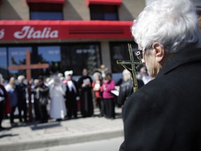 The Ninth Station of the Cross at Trattoria Caffe Italia. Parishioners from St. Anthony's church performed the Way of the Cross during Good Friday in Little Italy, one of a number of such processions in the region.