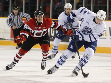 The Ottawa 67s Jared Steege, left, chases the Mississauga Steelheads Austin Osmanski during first period action of their OHL playoff hockey game at TD Place in Ottawa on Sunday, April 2, 2017.   (Patrick Doyle)  ORG XMIT: 0402 67s 01