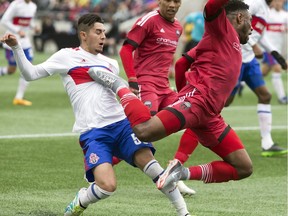Ottawa Fury FC's Eddie Edward goes airborne as Toronto FC II's Malik Johnson defends during the first half on Saturday April 22, 2017 at TD Place.