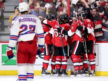 The Senators celebrate their tying goal in the third period.