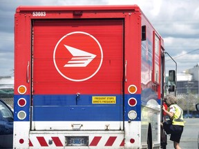 A cyclist's-eye view of a Canada Post truck.