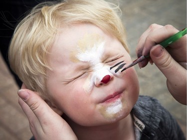 Three-year-old Brayden Hodges gets his face painted in front of the Canadian Tire Centre.