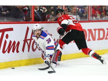 Tommy Wingels of the Ottawa Senators hits Mats Zuccarello of the New York Rangers.