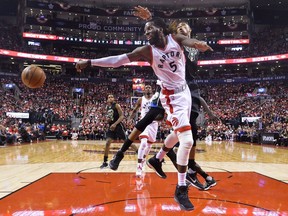 Toronto Raptors forward DeMarre Carroll (5) moves the ball past Milwaukee Bucks forward Giannis Antetokounmpo (34) during second half NBA round one playoff basketball action in Toronto on Monday, April 24, 2017.