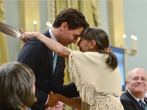 Justin Trudeau hugs Elder Evelyn Commanda-Dewache, a residential school survivor, during the closing ceremony of the Indian Residential Schools Truth and Reconciliation Commission, at Rideau Hall in Ottawa on June 3, 2015.