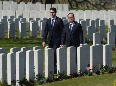Canadian Prime Minister Justin Trudeau and French President Francois Hollande visit the Cabaret-Rouge cemetery near Vimy Ridge, Sunday, April 9, 2017 near Arras, France.