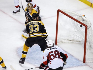 Boston Bruins' Tuukka Rask, of Finland, top and Zdeno Chara (33), of the Czech Republic, watch the shot by Ottawa Senators' Clarke MacArthur, not shown, enter the net during overtime in game six of a first-round NHL hockey Stanley Cup playoff series, Sunday, April 23, 2017, in Boston. The Senators won 3-2.