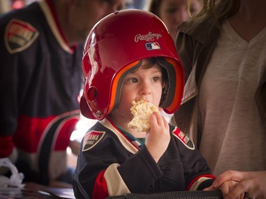 Two year old Mason Saray was watching the game while wearing his ball helmet and enjoying a rice crispy snack at St. Louis Bar and Grill on Elgin, along the Sens Mile Sunday April 23, 2017.   Ashley Fraser/Postmedia