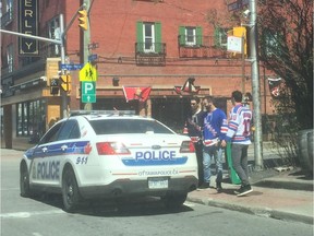 What's the problem, officers? Ottawa police monitor some suspicious sweaters on Sens Mile Saturday, as the city prepares for Game 2 of the series between the Senators and the New York Rangers.