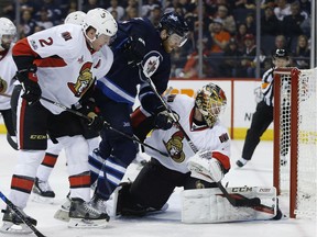 The Winnipeg Jets' Adam Lowry scores on Ottawa Senators goalie Mike Condon as Dion Phaneuf defends during the second period in Winnipeg on Saturday, April 1, 2017.