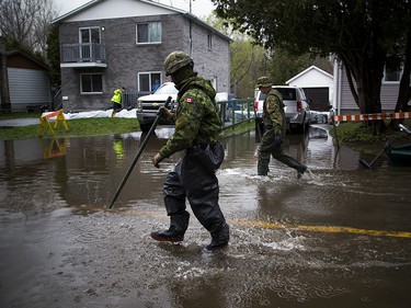 The Canadian Forces were called into Gatineau to help with the flooding in Gatineau Sunday May 7, 2017. CF members make their way into the flood waters along Rue Campeau Sunday afternoon.