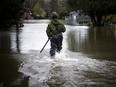 A Canadian Forces member makes his way into the flood waters along Rue Campeau Sunday afternoon.