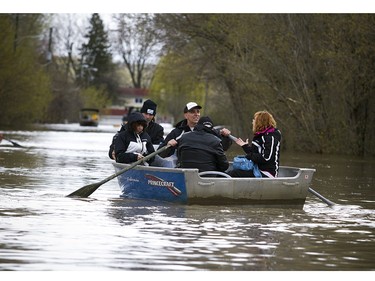 People use boats to get down Rue de Versailles as flooding has hit high levels in the east end of Gatineau Sunday May 7, 2017.