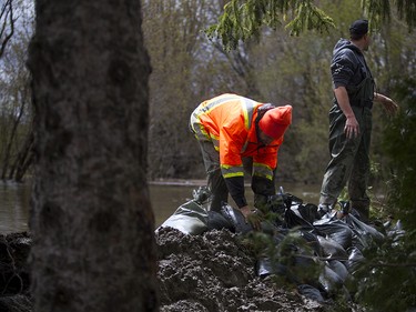 Volunteers were helping to build a levee dike to protect homes from flooding in the east end of Gatineau along Rue de Versailles Sunday May 7, 2017.