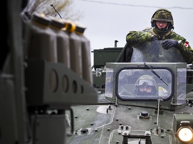 The Canadian Forces were called into Gatineau to help with the flooding in Gatineau Sunday May 7, 2017. CF members make their way along Rue Notre Dame.