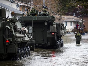 The Canadian Forces were called into Gatineau to help with the flooding in Gatineau Sunday May 7, 2017. CF members make their way along Rue Campeau.