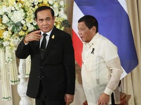 FILE - In this March 21, 2017 file photo, Philippine President Rodrigo Duterte, right, and Thailand&#039;s Prime Minister Prayuth Chan-ocha leave a joint news conference in Bangkok, Thailand. President Donald Trump is prioritizing strategic interests over human rights by inviting a pair of internationally criticized leaders from Southeast Asia, where the U.S. is vying with China for influence. The White House said rights concerns in the Philippines and Thailand may be aired in private. (AP Photo/Sakc