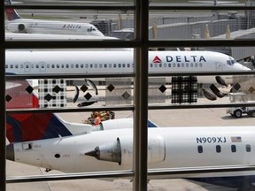 FILE - In this Monday, Aug. 8, 2016, file photo, Delta Air Lines planes are parked at Ronald Reagan Washington National Airport, in Washington. A California family says they were forced off a Delta plane and threatened with jail after refusing to give up one of their children&#039;s seats on a crowded flight. A video of the April 23, 2017, incident was uploaded to Facebook on Wednesday, May 3, 2017, and adds to the list of recent encounters on airlines that went viral, including the dragging of a pas