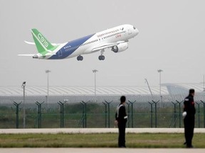 A Chinese-made C919 passenger jet takes off on its first flight at Pudong International Airport in Shanghai, Friday, May 5, 2017. The first large Chinese-made passenger jetliner took off on its maiden test flight, a symbolic milestone in China&#039;s long-term goal to break into the Western-dominated aircraft market. (AP Photo/Andy Wong, Pool)