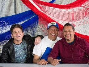 From left, Alfredo Rivas, Fredy Cruz and Nelson Gonzales, all originally from El Salvador, pose during a local fundraising party in Montreal, Sunday, April 9, 2017, where funds collected go to relatives back home. All three came to Canada in 1987. THE CANADIAN PRESS/Graham Hughes