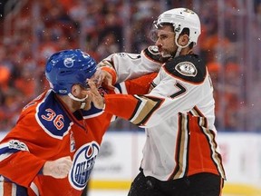 Anaheim Ducks&#039; Andrew Cogliano (7) and Edmonton Oilers&#039; Drake Caggiula (36) fight during the first period in game six of a second-round NHL hockey Stanley Cup playoff series in Edmonton on Sunday, May 7, 2017. THE CANADIAN PRESS/Jason Franson