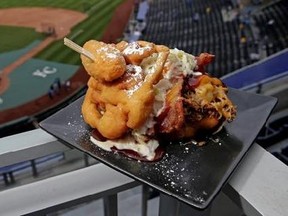 The Pulled Pork Patty Melt is seen at Kauffman Stadium before a baseball game between the Kansas City Royals and the Chicago White Sox on Tuesday, May 2, 2017, in Kansas City, Mo. The sandwich features pulled pork with cheese, bacon and cole slaw between a funnel cake bun and is topped with a jalapeno. (AP Photo/Charlie Riedel)