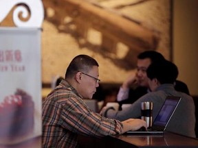 FILE - In this Feb. 16, 2015 file photo, a man surfs Internet on his laptop computer at a Starbuck cafe in Beijing. Security researcher say China&#039;s fondness for pirated software left it especially vulnerable to the latest global cyberattack. Beijing has tolerated rampant use of unlicensed software copies despite repeated promises to crack down and warnings by industry groups that China is leaving itself open to being hurt by malicious code. (AP Photo/Andy Wong, File)