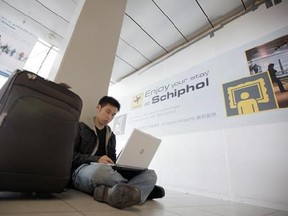 FILE - In this Saturday, April 17, 2010, file photo, a traveler from Malaysia uses his laptop computer at Schiphol Airport, Amsterdam, Netherlands. International air travelers might soon rediscover magazines, paperbacks and playing cards. Airline passengers have become hooked on their laptops and tablets to get work done or just kill time during long flights. But U.S. aviation-security officials appear determined to ban large electronic devices in the cabin of flights from Europe. (AP Photo/Pete