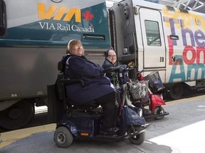 Martin Anderson and Marie Murphy are pictured in front of a Via Rail train at Toronto&#039;s Union Station on Saturday May 13, 2017. Via Rail has changed its policy on wheelchairs and other mobility aids to comply with a federal order demanding it make its trains more accessible to those who use the devices. The national rail provider had been fighting an order from the Canadian Transportation Agency to allow more than one mobility device at a time to be tied down on its trains, and unsuccessfully to