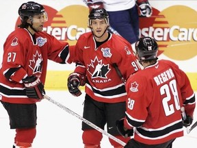 Team Canada&#039;s Joe Sakic is congratulated by teammates Scott Niedermayer (left) and Robyn Regehr following his goal against Team Slovakia during second period World Cup of Hockey Wednesday, Sept. 8, 2004 in Toronto. Sakic was one of eight inductees named to the 2017 class of the International Ice Hockey Federation Hall of Fame on Sunday. THE CANADIAN PRESS/Adrian Wyld