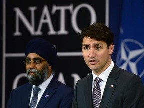 Minister of National Defence Minister Harjit Singh Sajjan stands with Prime Minister Justin Trudeau as he holds a press conference at NATO headquarters during the NATO Summit in Brussels, Belgium on Thursday, May 25, 2017. THE CANADIAN PRESS/Sean Kilpatrick