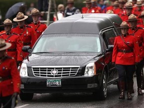 RCMP officers, municipal police departments, EMS and uniformed enforcement agencies march side by side along the Old Island Highway towards the Q Centre arena for the regimental funeral service for Const. Sarah Beckett in Colwood, B.C. on Tuesday, April 12, 2016. A man whose truck slammed into an RCMP officer&#039;s cruiser killing a 32-year-old constable has pleaded guilty to two charges in a Victoria-area court. THE CANADIAN PRESS/Chad Hipolito