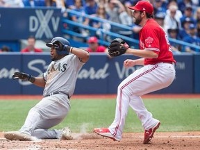 Texas Rangers shortstop Elvis Andrus (left) scores after a wild pitch from Toronto Blue Jays relief pitcher Dominic Leone (right) during seventh inning Major League baseball action in Toronto on Sunday, May 28, 2017.