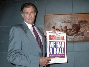 In this June 12, 1991, file photo, Frank Deford, editor and publisher of The National Sports Daily, holds a proof of the final front page of the newspaper after a news conference at the paper&#039;s offices in New York. Award-winning sports writer and commentator Frank Deford has died. He was 78. Deford passed away Sunday, May 28, 2017, in Key West, Florida, his family confirmed.