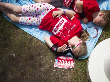 Nine-year-old Leia Bujold and her brother, seven-year-old William, chill out on a blanket before their races.