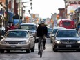 A cyclist travels along Bank Street in downtown Ottawa. (ERROL MCGIHON/THE OTTAWA SUN)