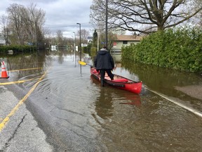 A Gatineau resident launches his canoe to go shopping Tuesday.