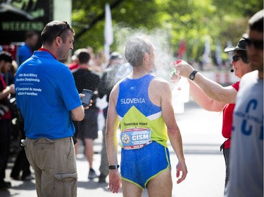 A runner gets sprayed with cool water after finishing the marathon Sunday May 28, 2017 at the Tamarack Ottawa Race Weekend.