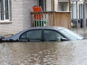 A submerged vehicle at a residence on Rue Saint-Patrice in Gatineau.