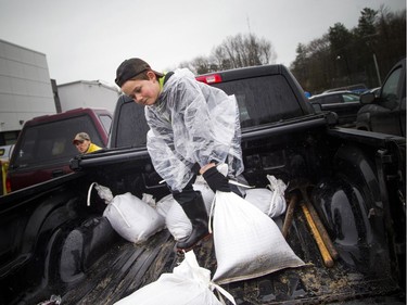 Alex McCalden, nine, puts his back into it as part of the volunteer effort at Constance and Buckham's Bay Community Centre filling sandbags and loading up trucks Saturday morning. Constance Bay has been hit with major flooding May 6, 2017.