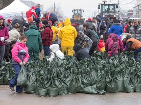 All sorts of volunteers are pitching in with sandbagging at Rue Saint-Louis and Rue Moreau in Gatineau as flooding continues throughout the region in areas along the local rivers. Citizen columnist Tyler Dawson was on the scene, riding along with those volunteering. Wayne Cuddington/Postmedia