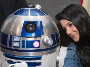Arryn Zech, one of the celebrities on hand, takes a selfie with R2D2 as the annual Ottawa Comiccon gets underway at the EY Centre.  Wayne Cuddington/Postmedia